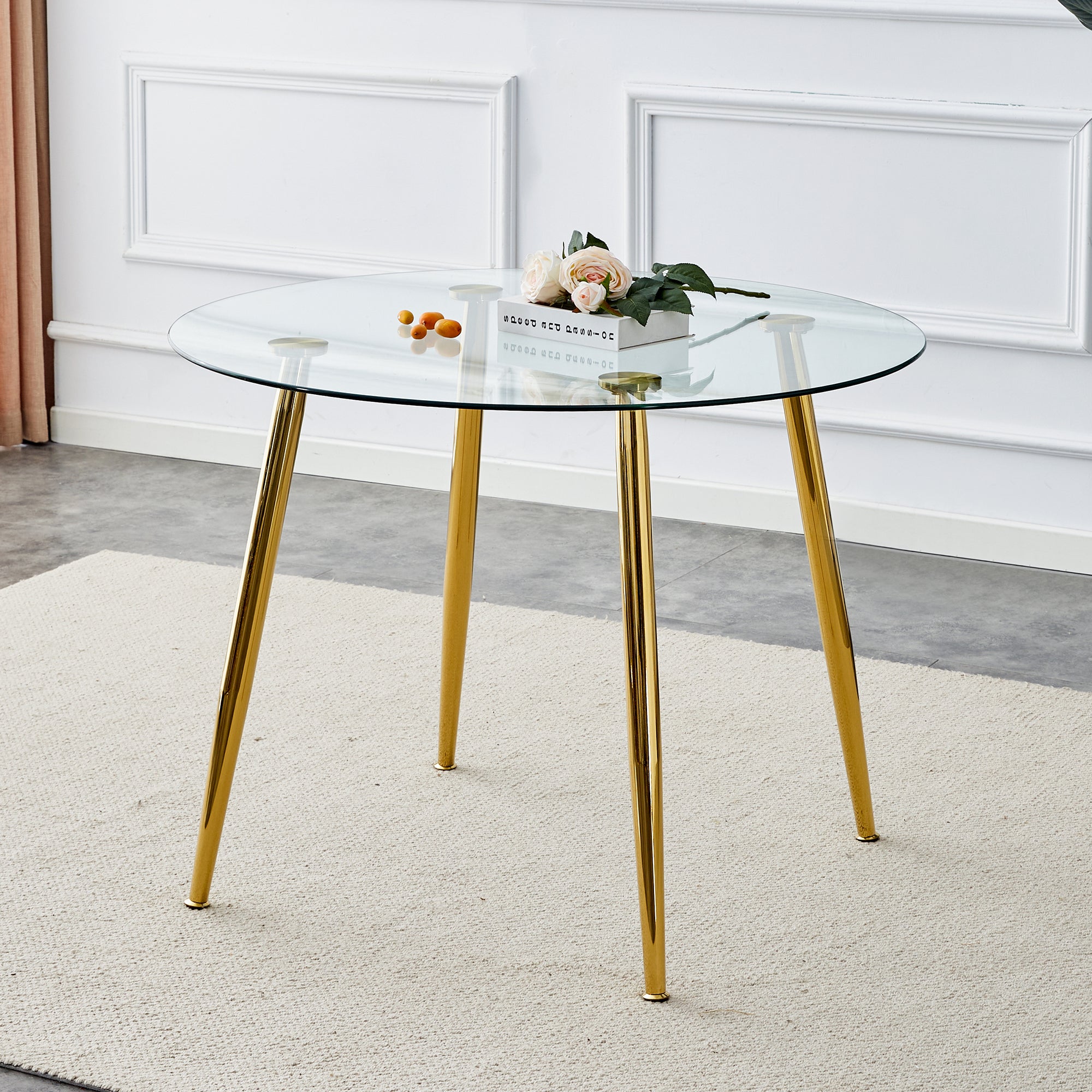 A glass tabletop with a diameter of 40 inches and a modern minimalist circular dining table with gold plated metal legs. 40 '* 40' * 30 ' DT-1164