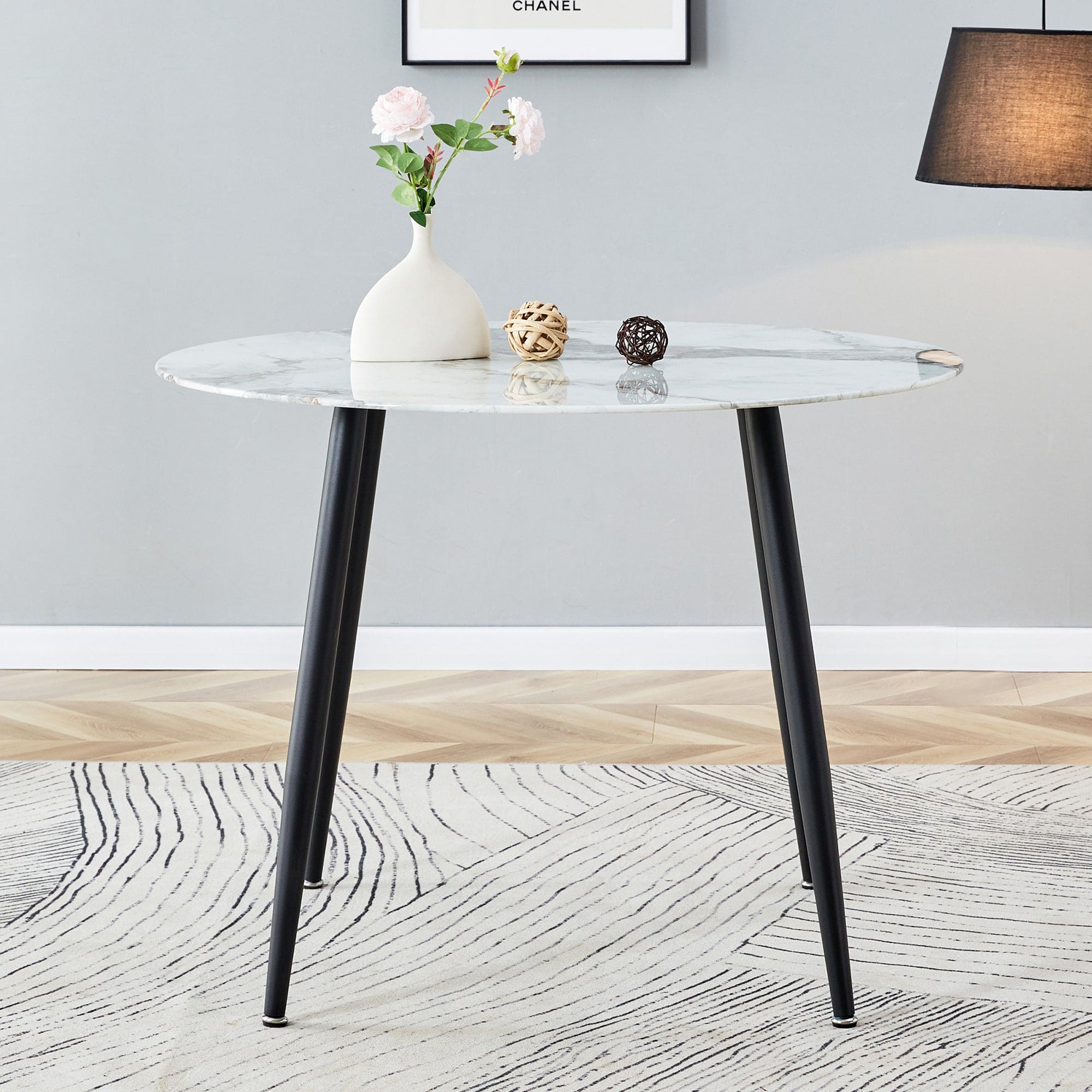 A modern minimalist circular dining table with a diameter of 40 inches, a 0.3 inch thick white imitation marble pattern tabletop and black metal legs  40 '* 40' * 30 'DT-1164