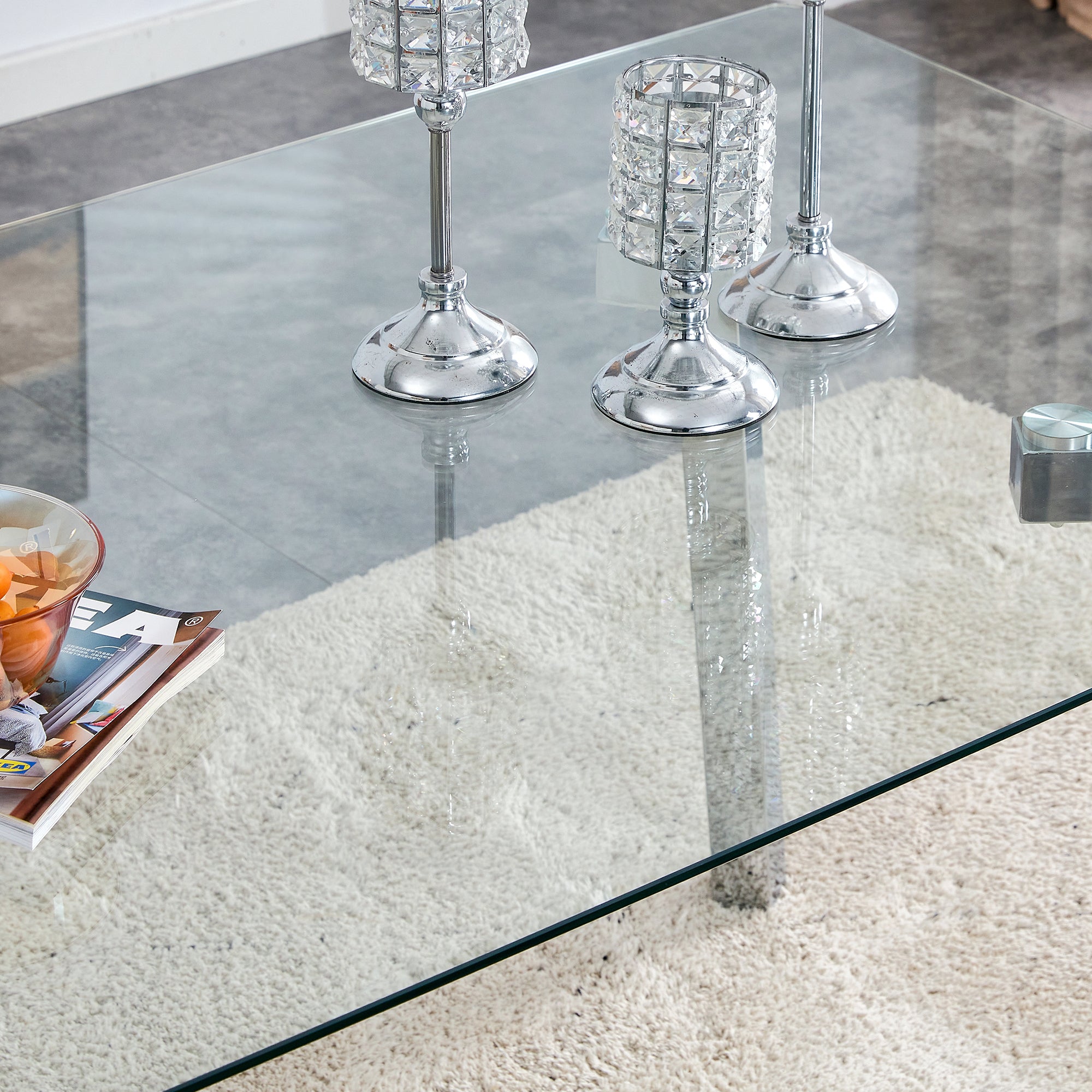 A modern minimalist rectangular glass dining table with tempered glass tabletop and silver metal legs, suitable for kitchens, restaurants, and living rooms,63"*35.4"*30"