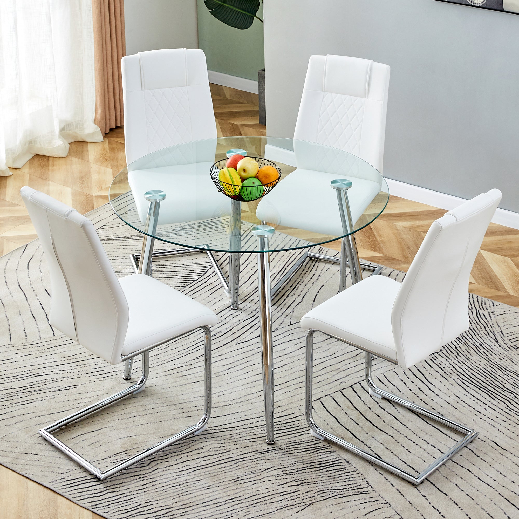 Table and chair set. (1 table+4 chairs set) A circular dining table with a 40 inch diameter glass tabletop and electroplated  metal legs. 4 white PU chairs DT-1164 001