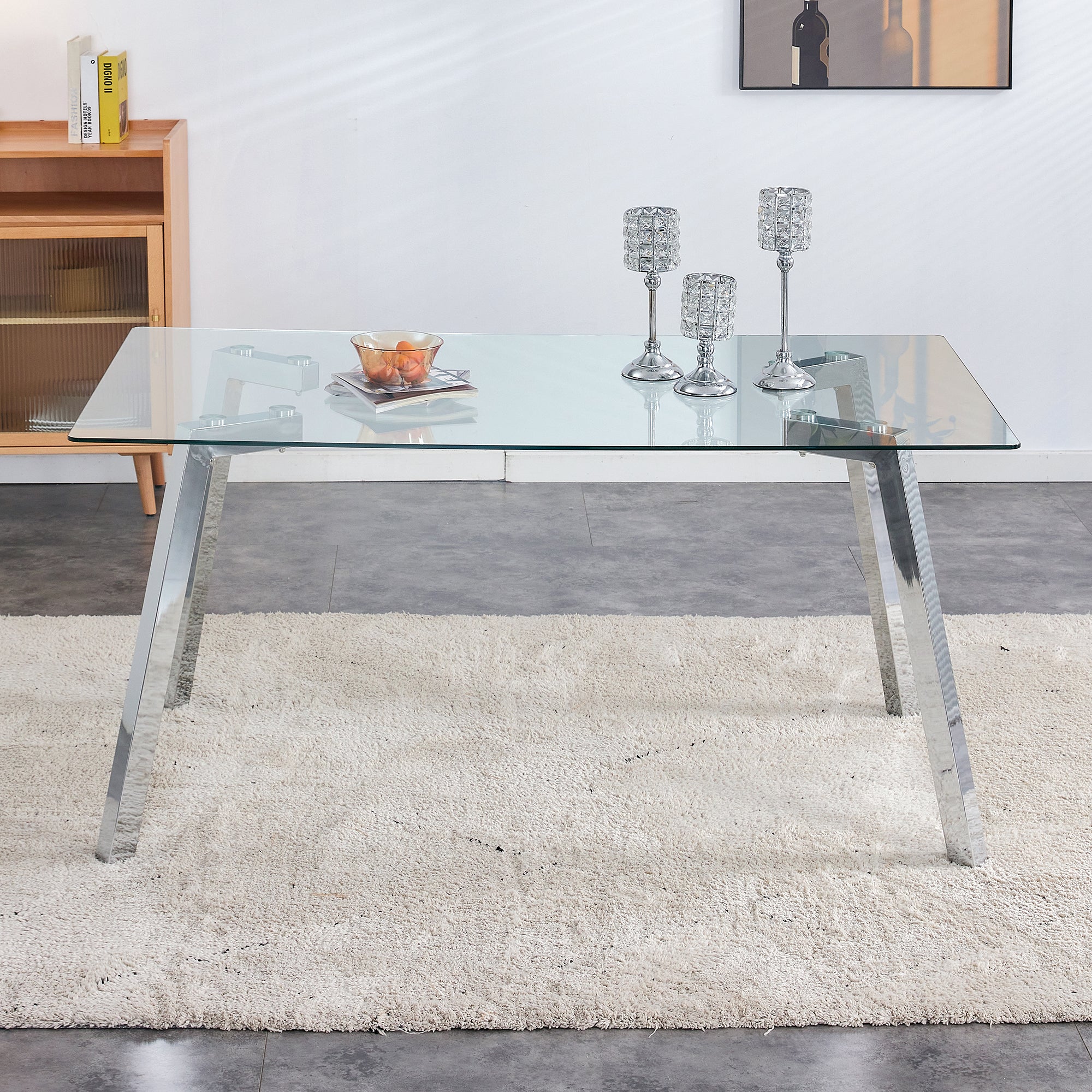 A modern minimalist rectangular glass dining table with tempered glass tabletop and silver metal legs, suitable for kitchens, restaurants, and living rooms,63"*35.4"*30"