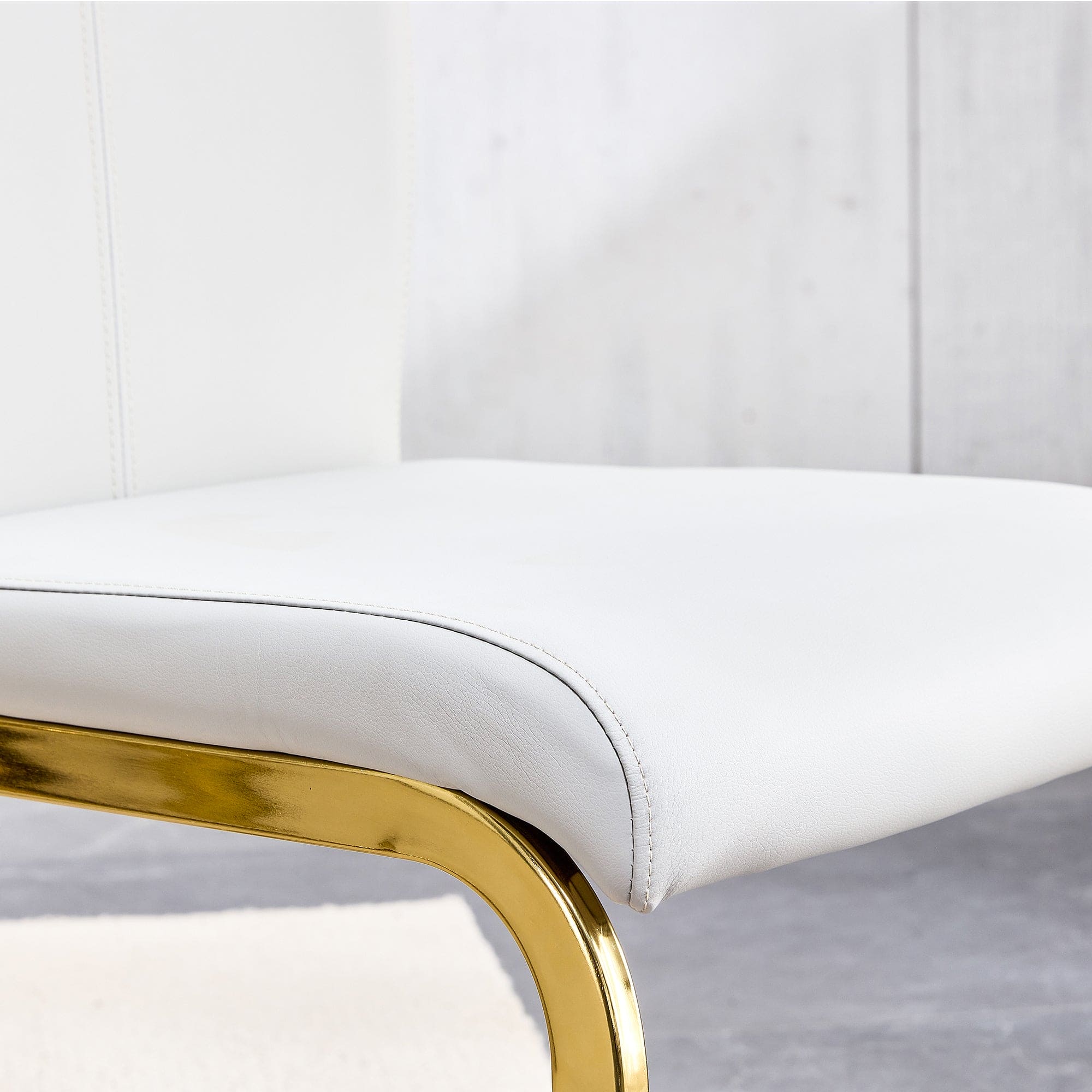 Table and chair set. 1 table and 4 white PU backrest cushions with gold metal leg chairs . A rectangular white imitation marble desktop with MDF legs and gold metal decorative strips. HH1162