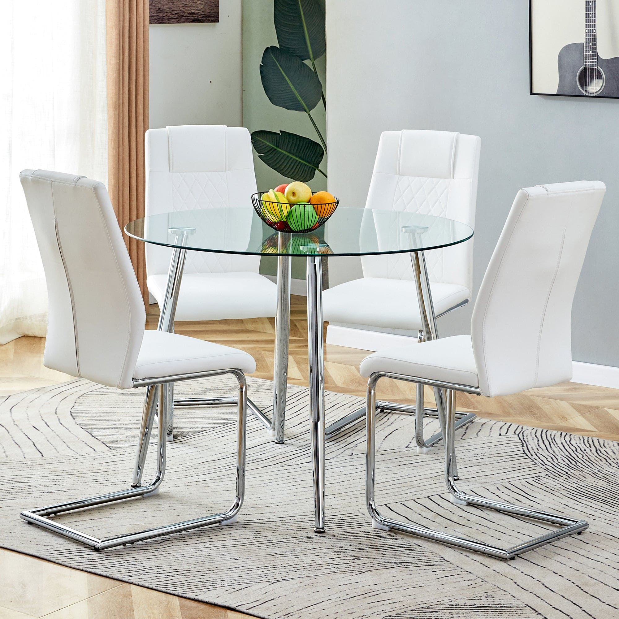 Table and chair set. (1 table+4 chairs set) A circular dining table with a 40 inch diameter glass tabletop and electroplated  metal legs. 4 white PU chairs DT-1164 001