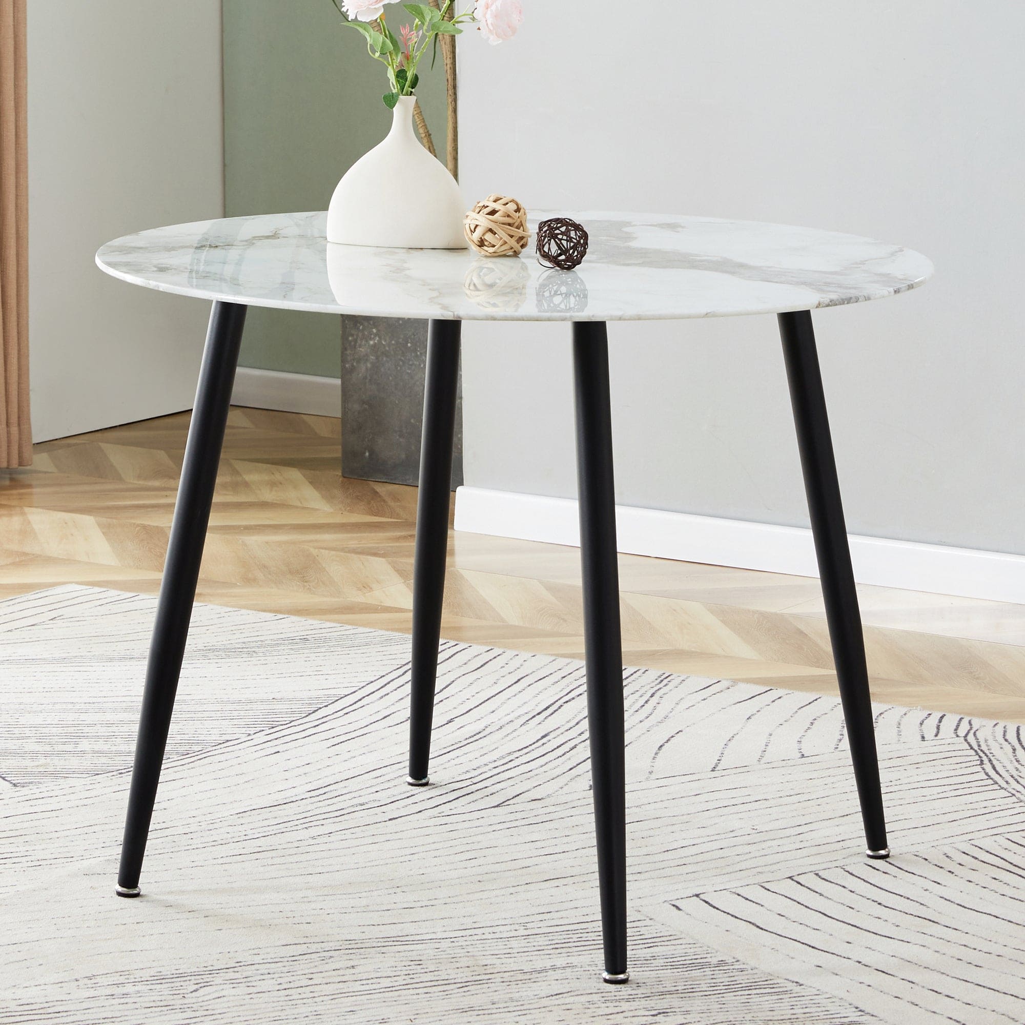 A modern minimalist circular dining table with a diameter of 40 inches, a 0.3 inch thick white imitation marble pattern tabletop and black metal legs  40 '* 40' * 30 'DT-1164