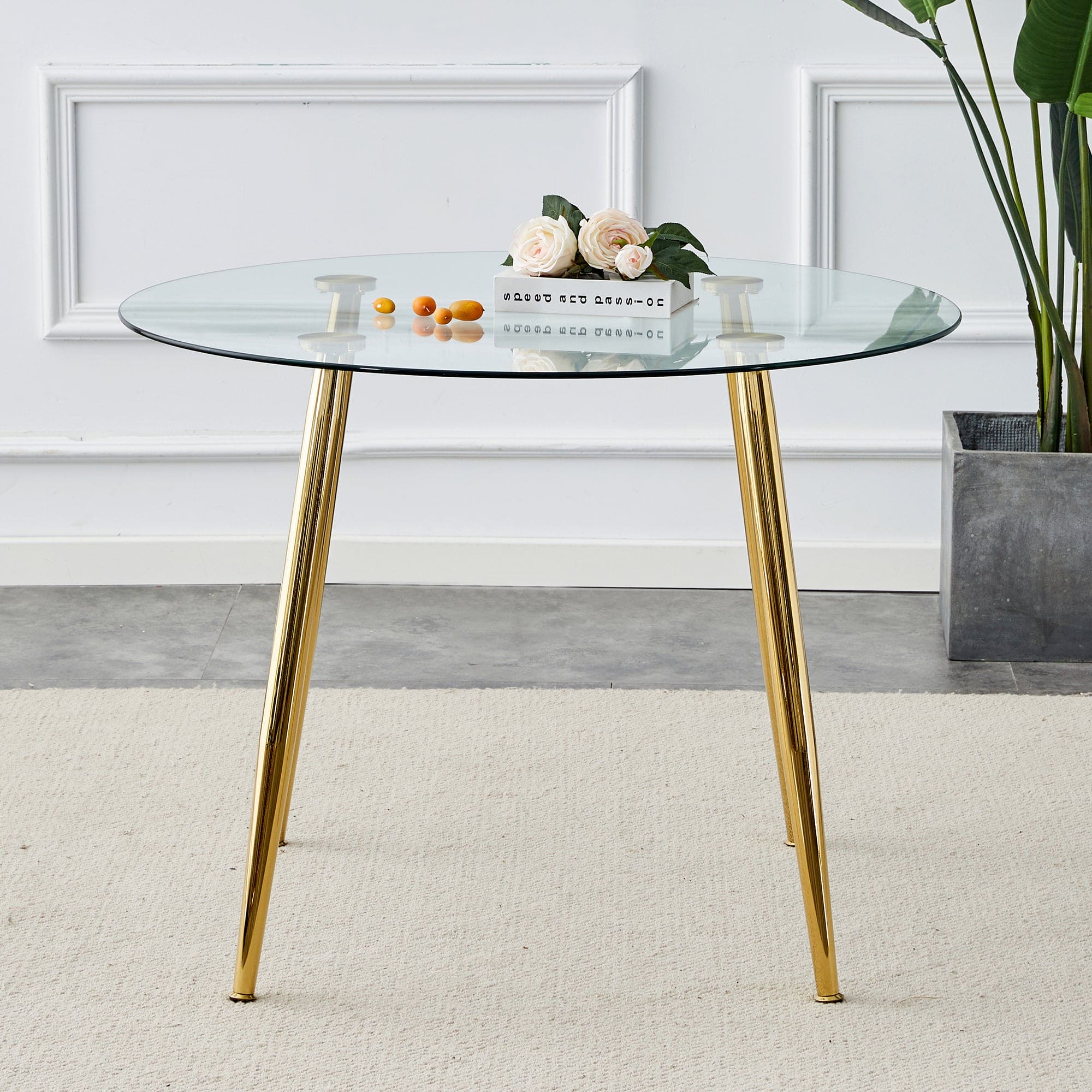 A glass tabletop with a diameter of 40 inches and a modern minimalist circular dining table with gold plated metal legs. 40 '* 40' * 30 ' DT-1164