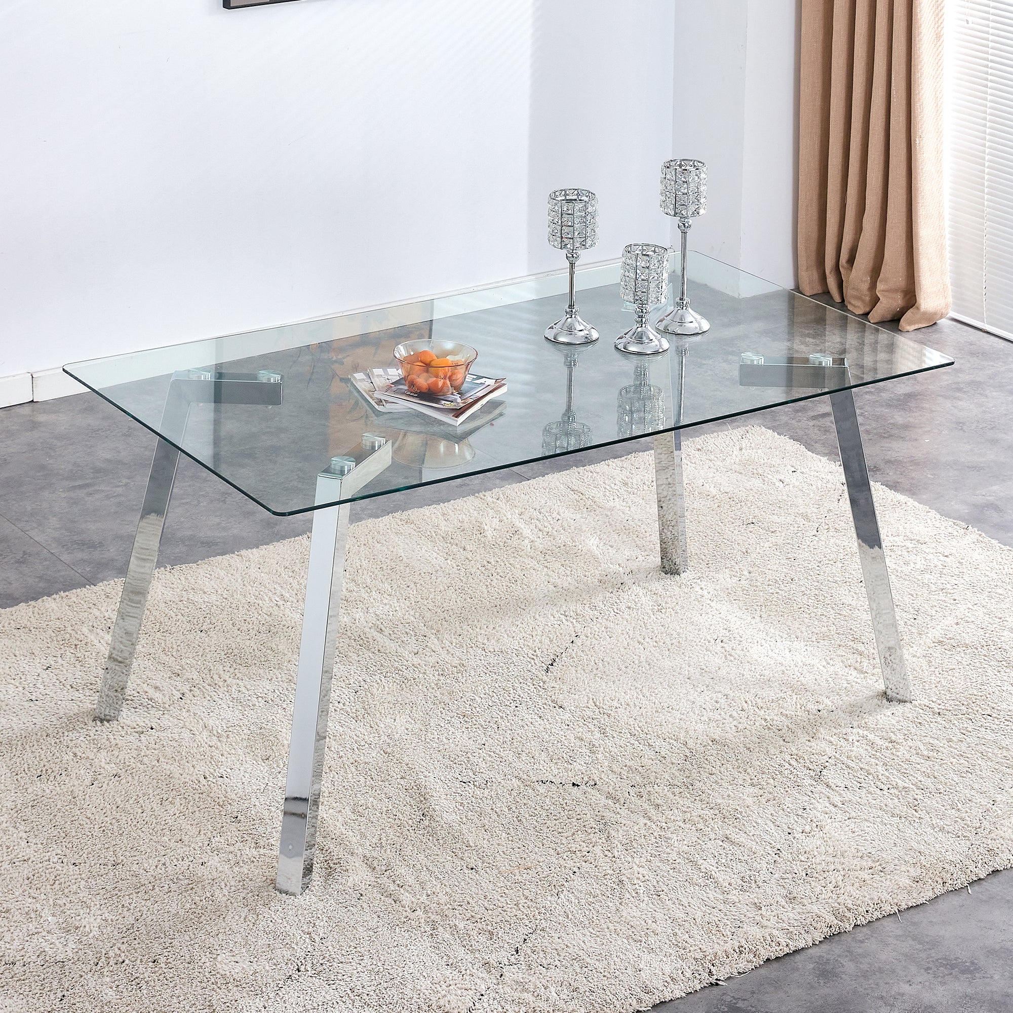 A modern minimalist rectangular glass dining table with tempered glass tabletop and silver metal legs, suitable for kitchens, restaurants, and living rooms,63"*35.4"*30"