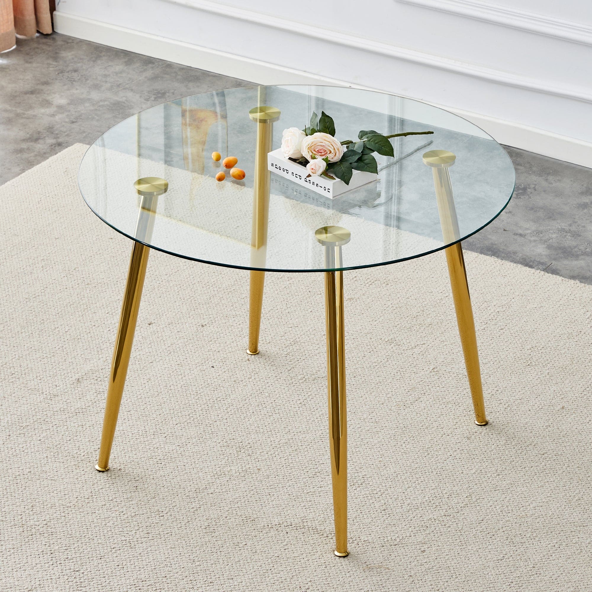 A glass tabletop with a diameter of 40 inches and a modern minimalist circular dining table with gold plated metal legs. 40 '* 40' * 30 ' DT-1164