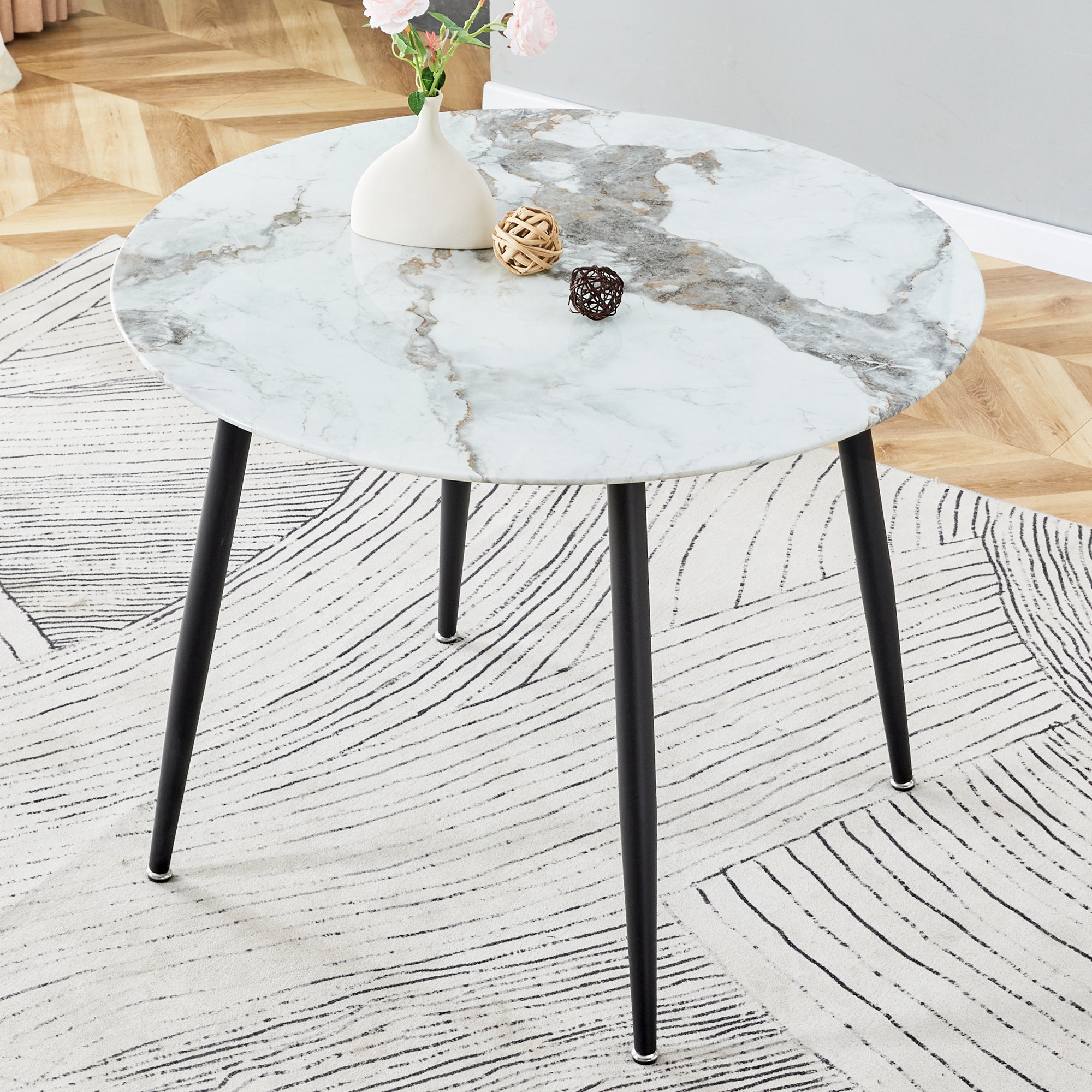 A modern minimalist circular dining table with a diameter of 40 inches, a 0.3 inch thick white imitation marble pattern tabletop and black metal legs  40 '* 40' * 30 'DT-1164