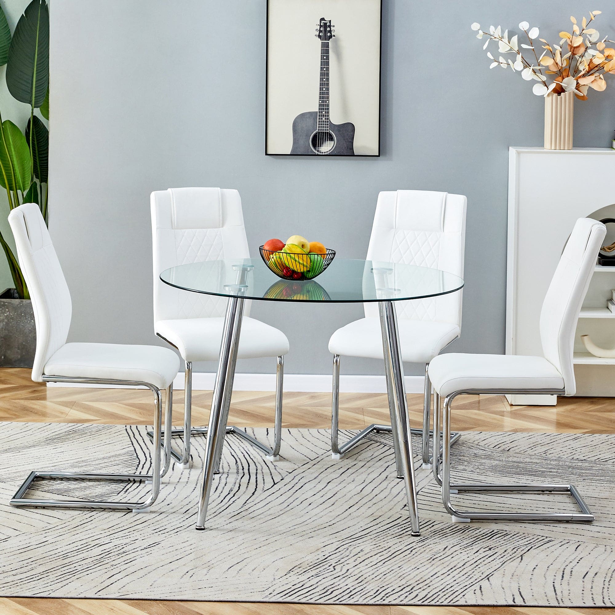 Table and chair set. (1 table+4 chairs set) A circular dining table with a 40 inch diameter glass tabletop and electroplated  metal legs. 4 white PU chairs DT-1164 001